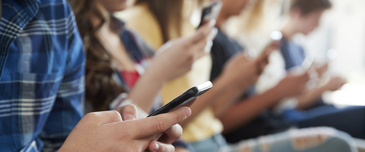 Photograph of young people using smartphones